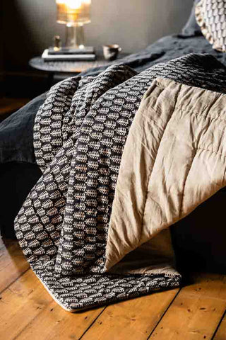 Lifestyle image of the Black & Natural Leaf Reversible Cotton Throw - 2 Sizes Available