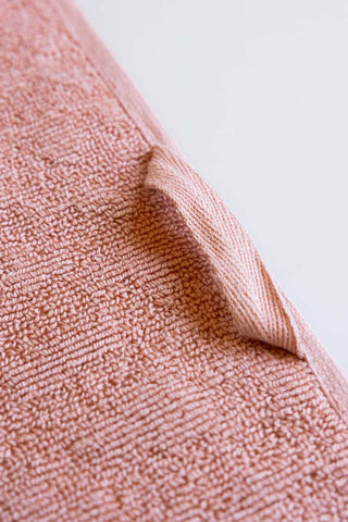 Detail shot showing the hanging hook on the Leopard Jacquard Towels in Dusty Pink. 