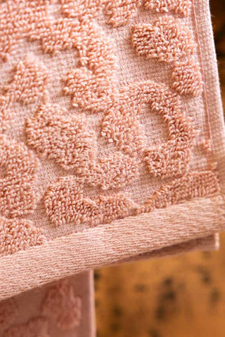 A close up image of the jacquard pattern of the Leopard Jacquard Towels in Dusty Pink. 