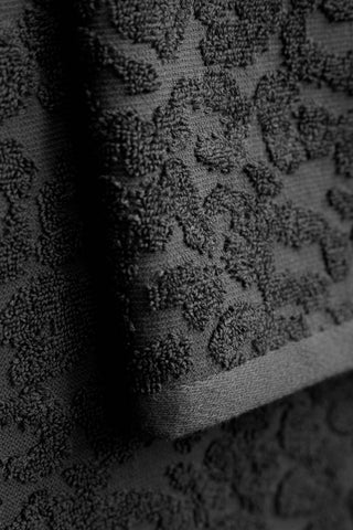 A close up of the jacquard detailing on the Leopard Jacquard Towels in Jet Black. 
