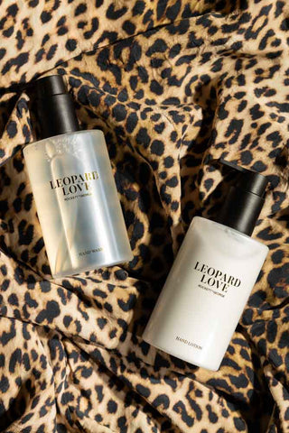 The Leopard Love Hand Care Duo Gift Set seen from above, displayed on some leopard print fabric.