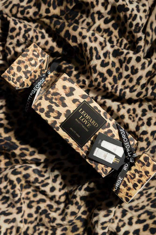 The Leopard Love Hand & Body Beauty Cracker styled on some leopard print fabric.