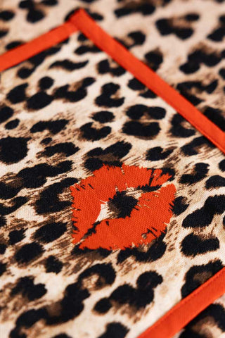 Leopard print fabric with a red lip-shaped patch