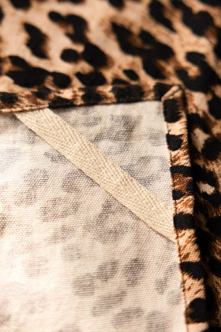 Close-up of the concealed hanging hook on the back of the Leopard Love Print Tea Towel.