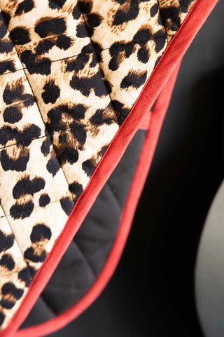 Detail shot of the piping on the Leopard Love Print & Red Detailing Oven Gloves.