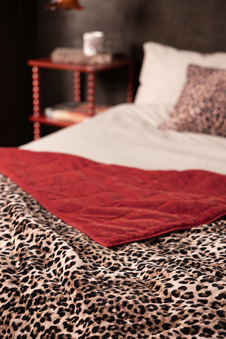 Close-up image of the Leopard Love Print with Red Reversible Quilt