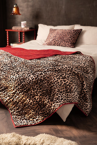 Lifestyle image of the Leopard Love Print with Red Reversible Quilt