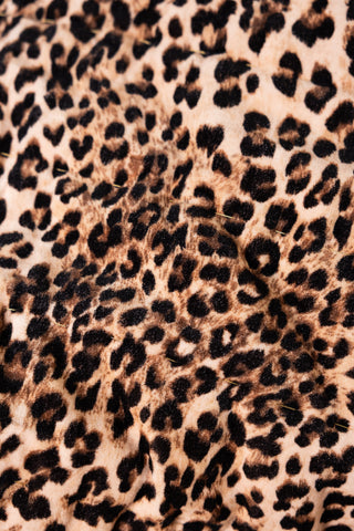 Close-up image of the leopard print on the Leopard Love Print with Red Reversible Quilt