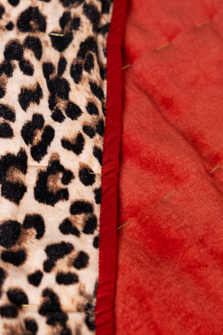 Image of the material for the Leopard Love Print with Red Reversible Quilt