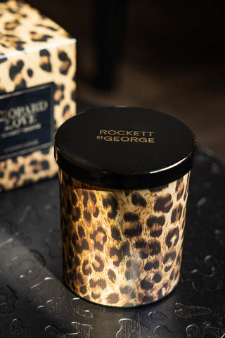 The Leopard Love Scented Candle with the box in the background.