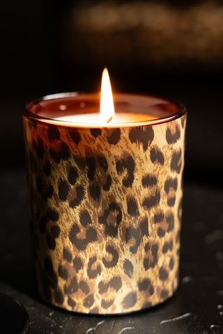 Close-up of the lit Leopard Love Scented Candle.