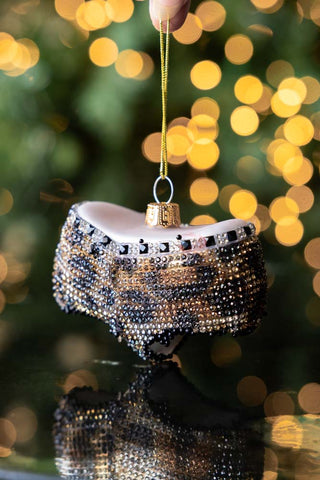Leopard Print Bikini Bottom Christmas Tree Decoration held up with lights in the background.