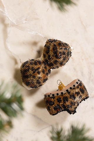 The Leopard Print Bikini Christmas Tree Decorations on a marble table top