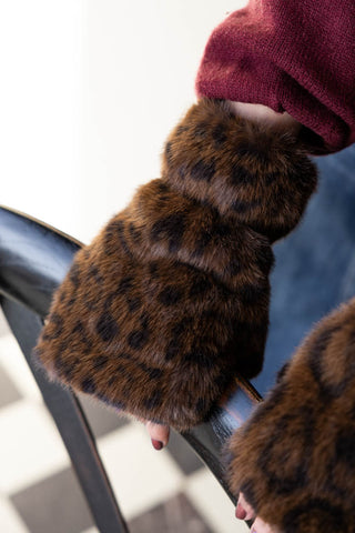 Close-up of the Leopard Print Faux Fur Handwarmers being worn by a model.
