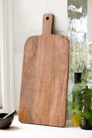 Back of the Leopard Print Tall Wooden Serving Board, shown against white zellige kitchen tiles. 