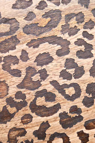 The leopard print pattern etched into the surface of the Leopard Print Tall Wooden Serving Board. 