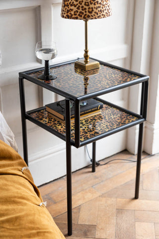 Lifestyle image of the Leopard Print & Glass Bedside Table