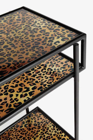Close-up of the Leopard Print & Glass Console Table on a white background.