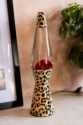 Leopard Print & Red Lava Lamp shown with the lamp off against a plaster wall. 
