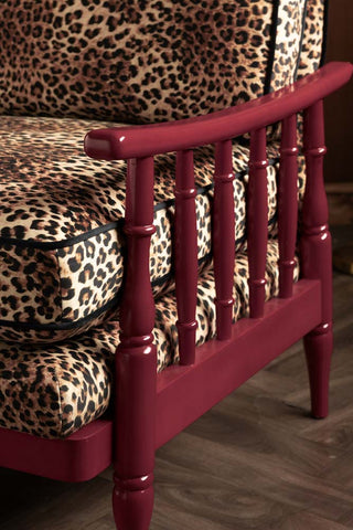 The spindle arm in dark red on the Leopard Print & Red Rebel Spindle Armchair. 