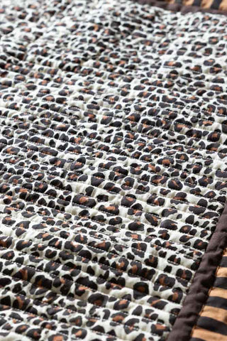 Close-up image of the Leopard Print & Striped Reversible Quilt