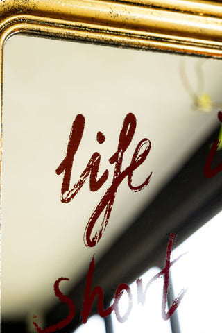 Close up showing the lipstick writing style text on the Life Is Short, Flirt With Me Mirror 