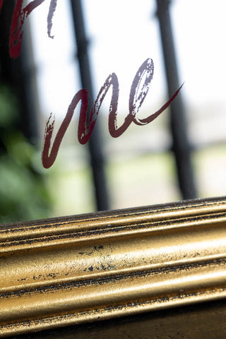 A close up image showing the details of the frame and writing on the Life Is Short, Flirt With Me Mirror.