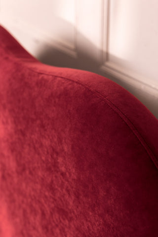 A detail of the headboard of the Lips Bed in Cherry Red Needlecord Velvet. 