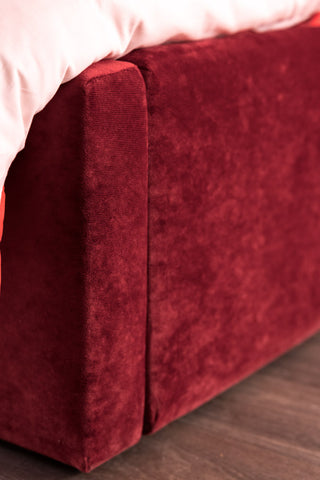 The foot of the Lips Bed in Cherry Red Needlecord Velvet 