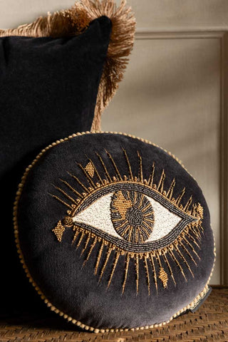 Look Of Love Embroidered Black Velvet Cushion styled against a black velvet cushion with gold fringing and neutral walls. 