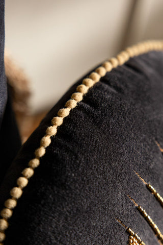detail shot of the pom pom piping on the Look Of Love Embroidered Black Velvet Cushion