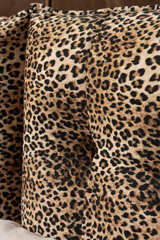 A close up detail of the buttoned cushion that forms the headboard of the Lounge Lover Bed in Leopard Print Velvet. 