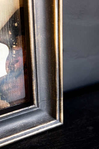 Close-up of the frame of the Vintage-Style Love Wins Framed Wall Art.