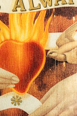 Close-up of the Love Always Wins Fringed Velvet Cushion.