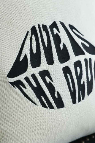 Close-up image of the Love Is The Drug Knitted Lips Cushion