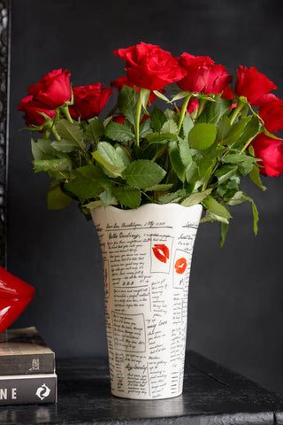 The Love Letters Flower Vase shown with red roses against a black background. 