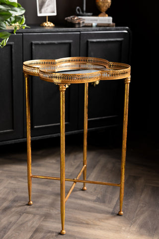 A side view of the Lucky Clover Mirrored Side Table, showing the distressed gold finish. 