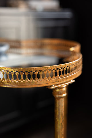 A detail image showing the detailing on the side of the Lucky Clover Mirrored Side Table tabletop. 