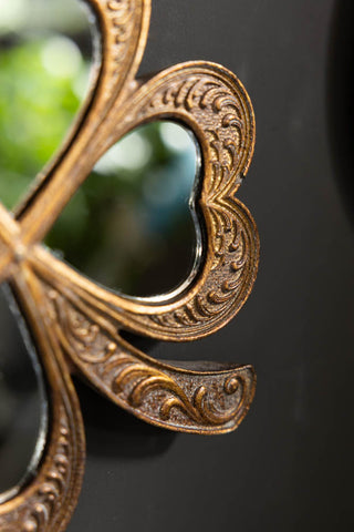 The corner of the Lucky Clover Small Gold Wall Mirror. 