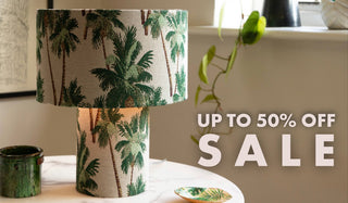 A palm print table lamp with the words 'up to 50% off sale'.