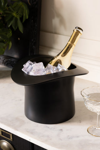 The Matte Black Top Hat Wine Cooler shown with a champagne bottle and ice inside. 