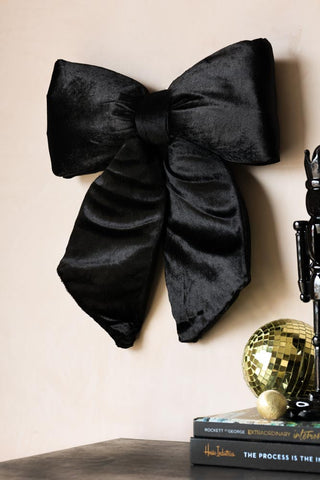 Lifestyle image of the Medium Black Plush Bow Christmas Decoration