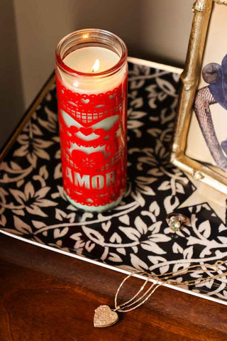 Lifestyle image of the Mexican Folk Art Candle in Red shot from above