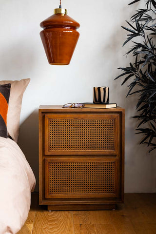 Lifestyle image of the Mid-Century Rattan Bedside Table