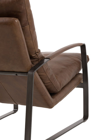 The Minimalist Brown Leather Lounge Chair seen from the back, on a white background.