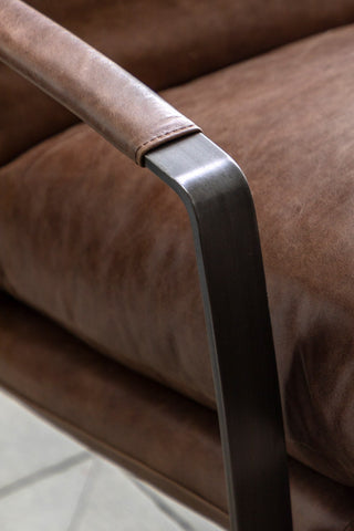 Close-up of the arm of the Minimalist Brown Leather Lounge Chair.