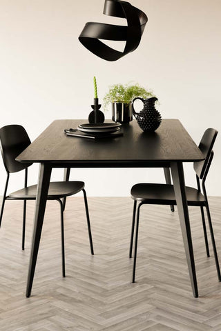 Lifestyle image of the Modern Black Dining Table against a white background