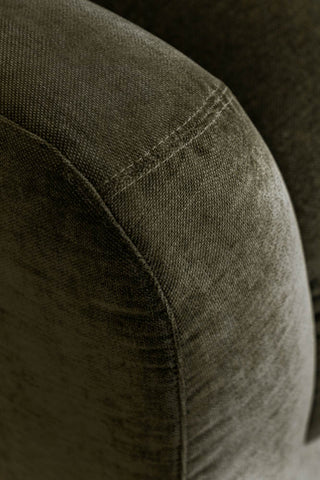 Close-up of the arm of the Modern Curved Armchair in Olive Green.