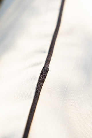 Close-up of the piping on the Monochrome Butterfly Outdoor Cushion.