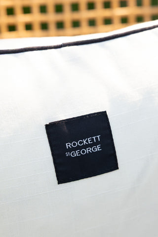 Close-up of the Rockett St George label on the Monochrome Butterfly Outdoor Cushion.